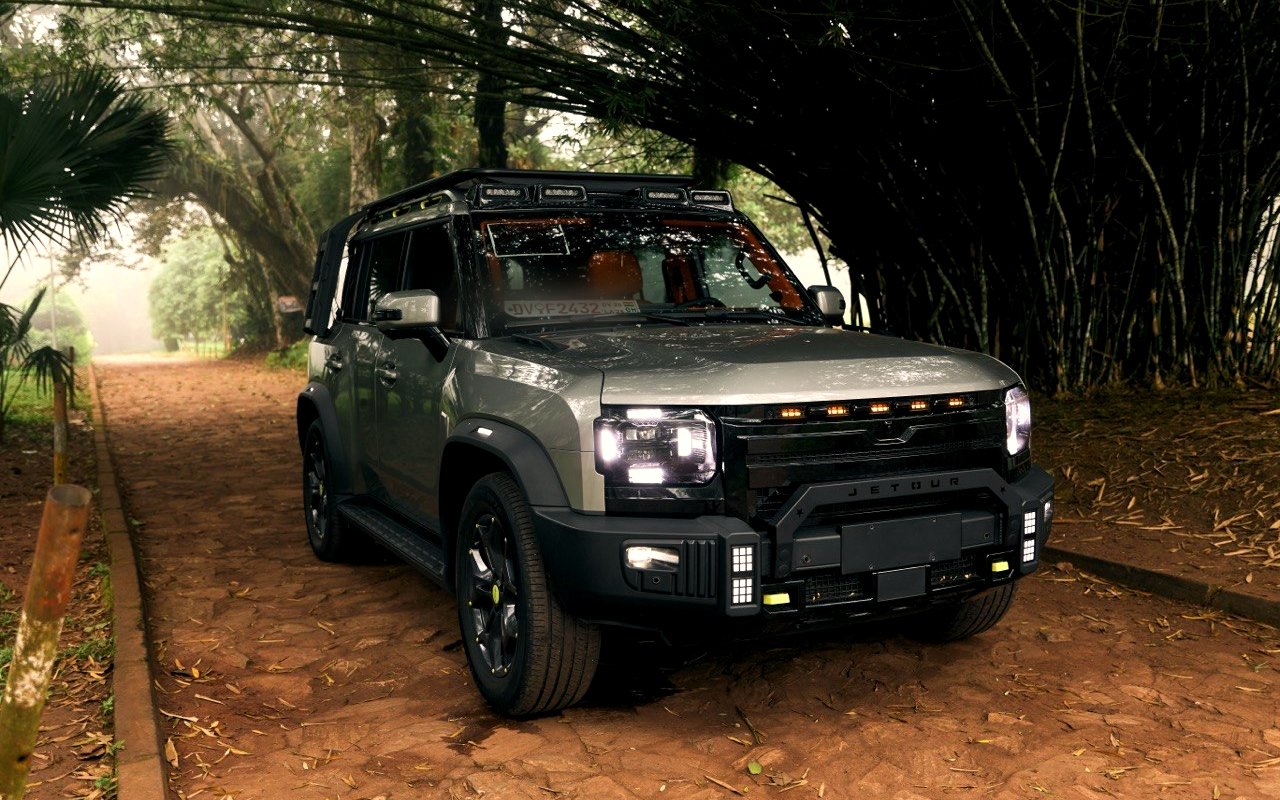 Jetour T2 Traveller+ parked in a bamboo grove, headlights on